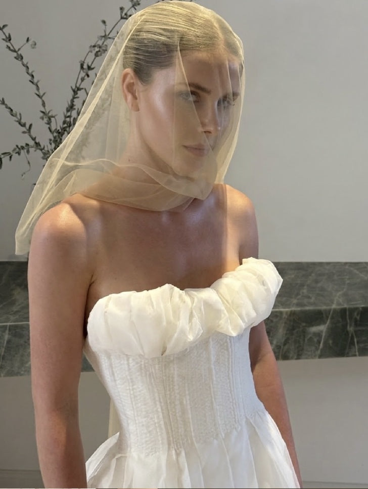 Silk organza corset wedding dress worn under a tulle veil