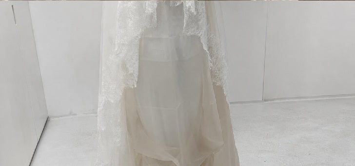 Lace edged wedding veil on a mannequin in the L'eto atelier