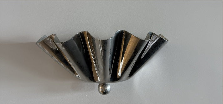 Sculptural metal wall light in the L'eto studio